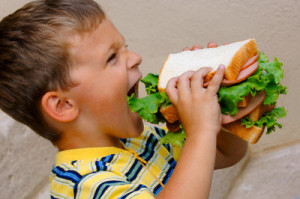 Boy Eating Huge Sandwich